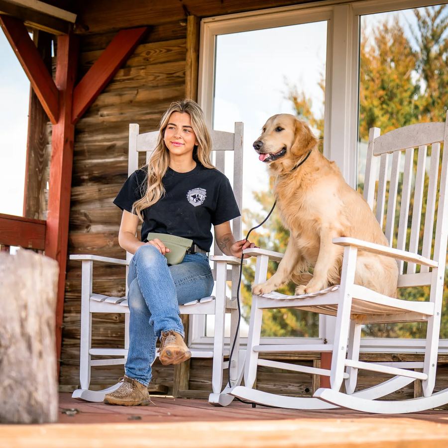 Rebeka on a porch with a golden retriever