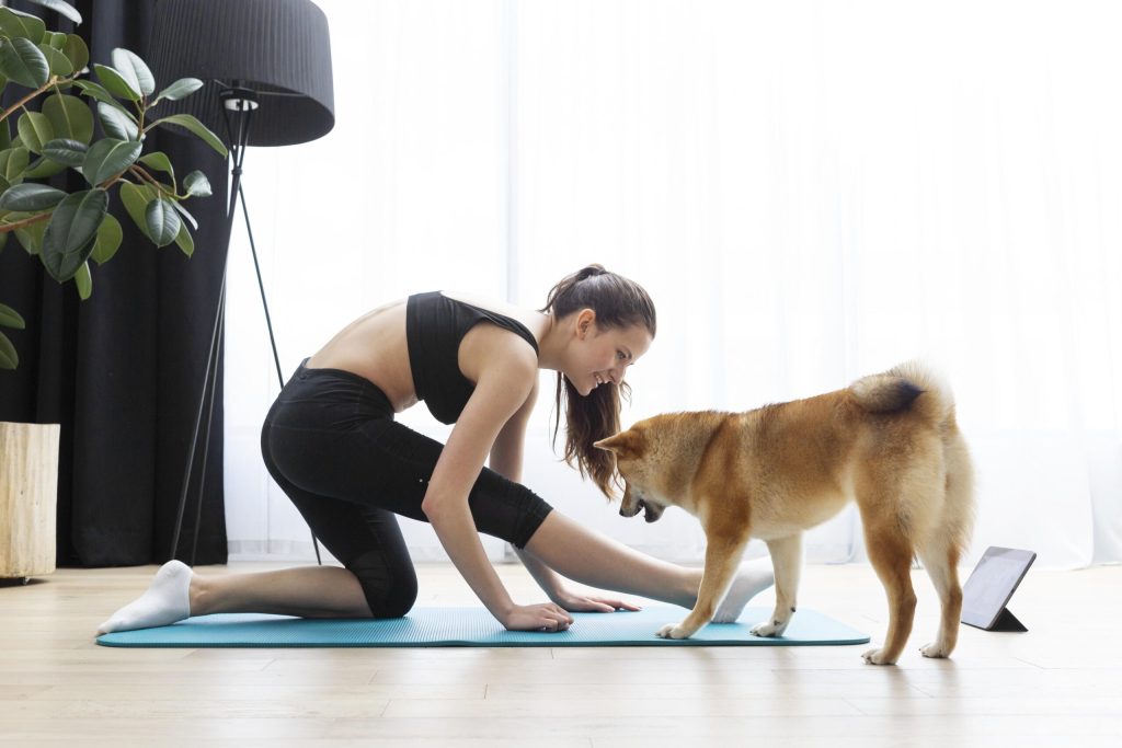 young woman doing yoga her dog scaled 1